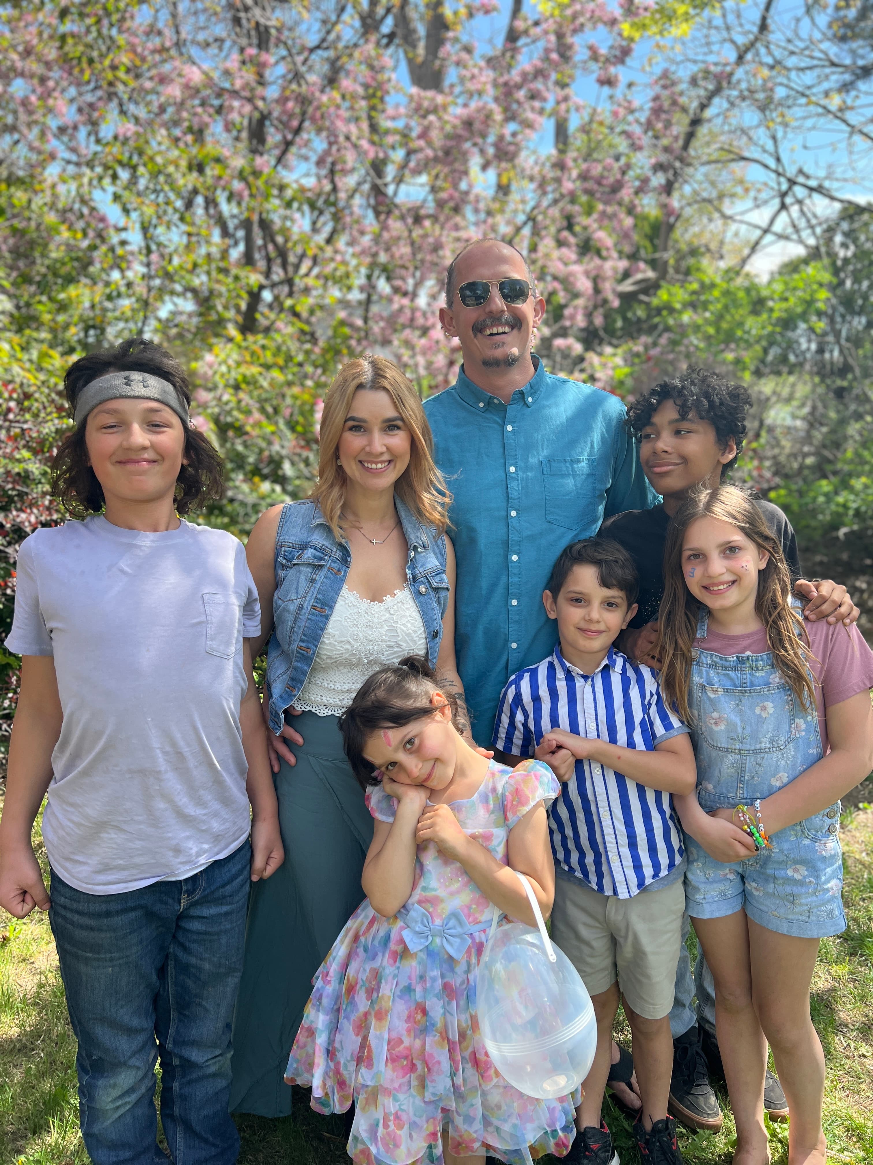 Daniel Harder, Courtney, and their five children under the cherry blossom trees
